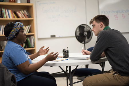 Two students talking an a classroom at Marian University