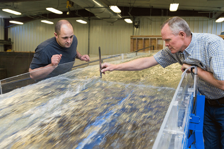 Researchers in a lab studying water flow at Utah State University
